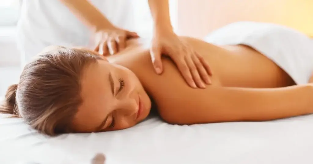 Women getting a relaxing massage therapy on her back at a spa in Corpus Christi, TX